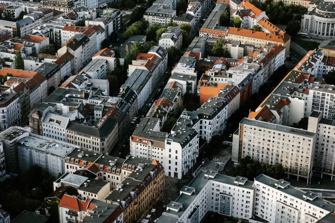 Luftbild dicht bebauter Altbaublöcke mit roten Dächern und schmalen Innenhöfen