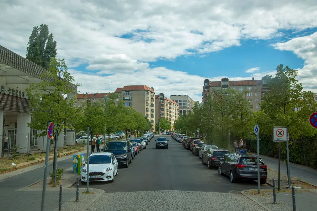 Ruhige Wohnstraße mit beidseitig parkenden Autos und einem Tempo-30-Schild